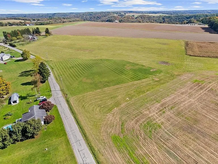 Aerial view of open fields and a new-build site
